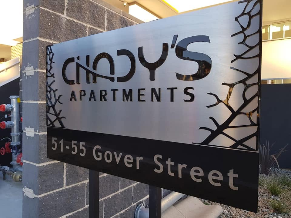 Laser-cut steel post sign for Chady's Apartments