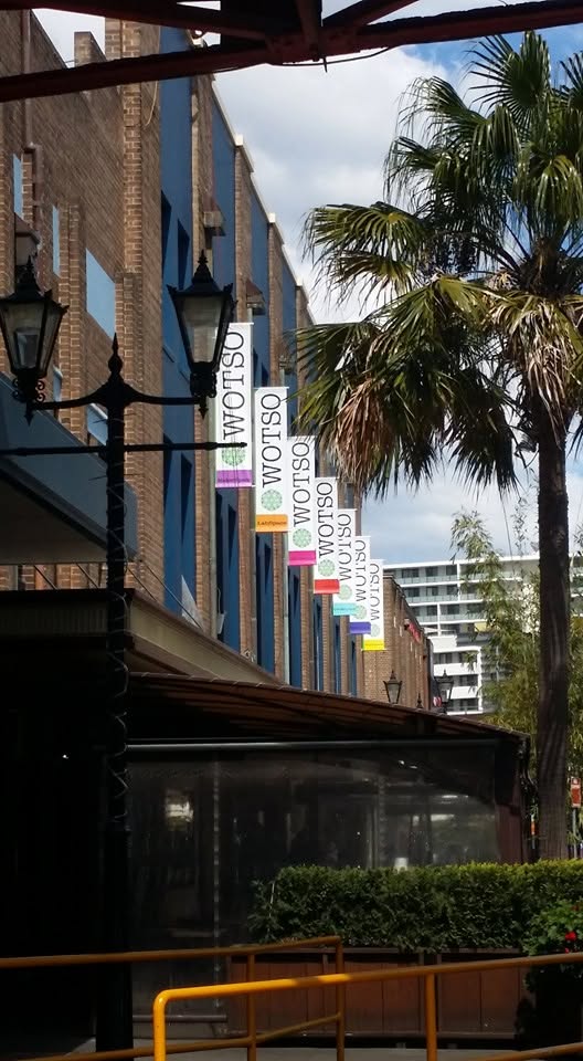 Row of WOTSO blade banners along a heritage shopping strip