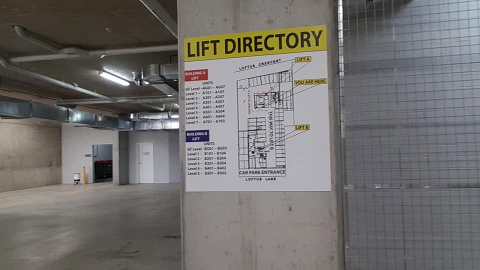 Lift directory panel with building map in a car park