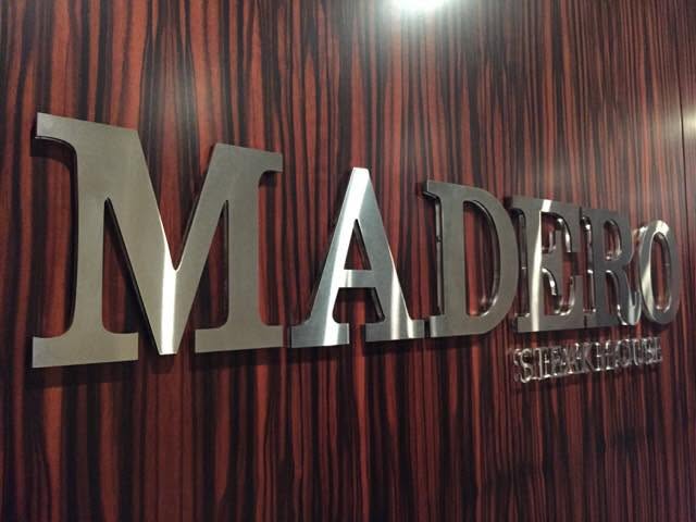 Brushed stainless letters for Madero Steak House on timber panelling