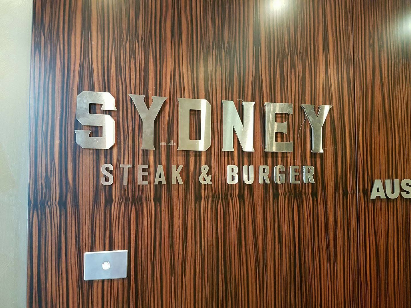Stainless steel letters fitted to timber panelling, Sydney Steak and Burger