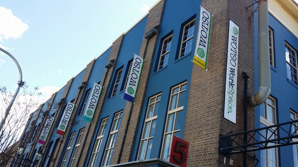 Row of printed blade banners on a blue heritage building for WOTSO