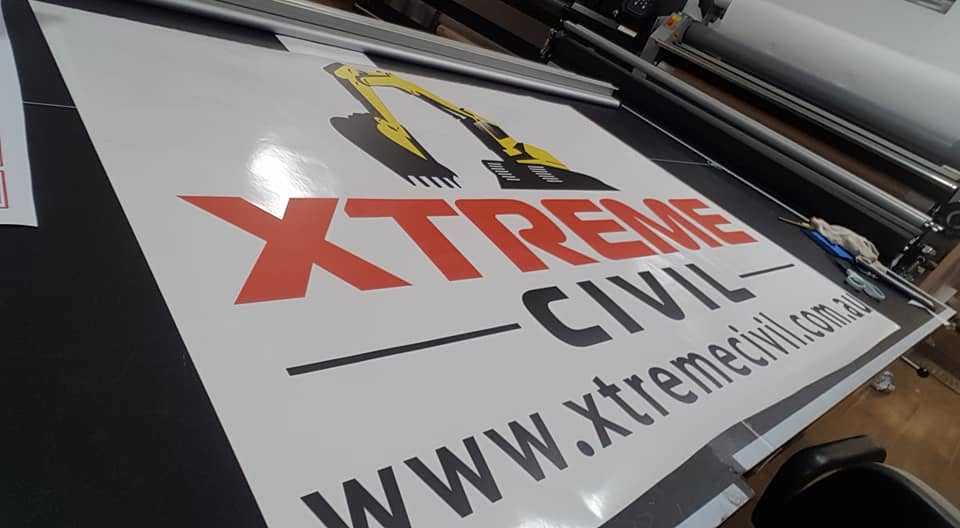 Large-format Xtreme Civil banner coming off the laminator