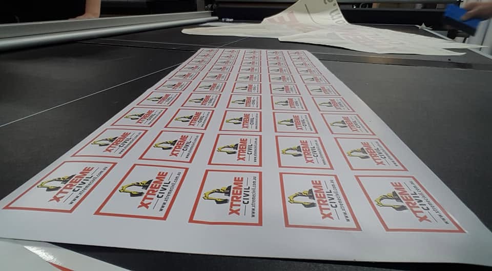 Sheets of cut Xtreme Civil stickers on the plotter